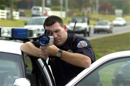 Police officer shooting a Kustom ProLaser II lidar gun