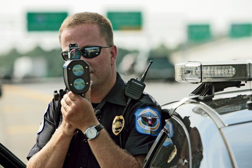 10 Frequently Asked Questions about Radar Detectors: Police officer shooting laser