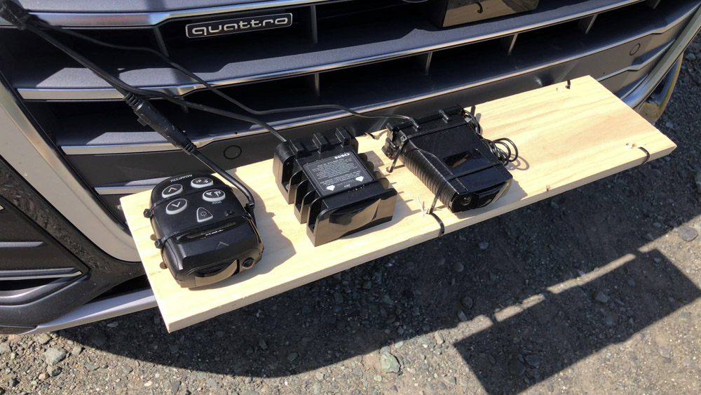 Radar detectors mounted on wooden mount on grill