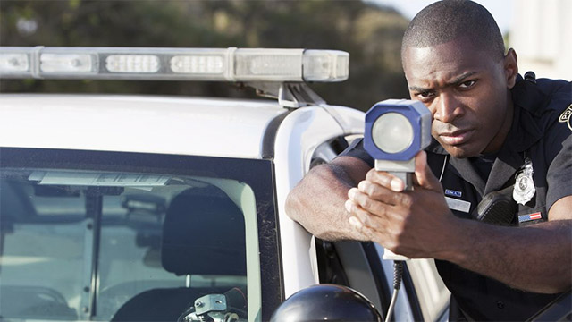 Officer shooting Kustom Talon radar gun